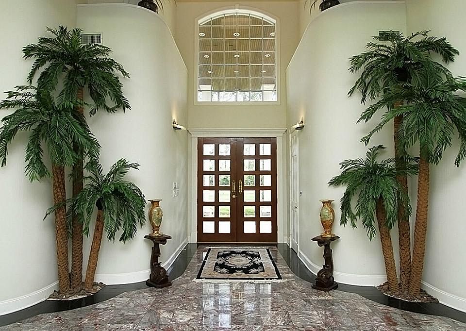 Upon entering this phenomenal custom built masterpiece, you'll notice the attention to detail given throughout. Double-leaded glass doors grace the breathtaking entry which boasts beautiful marble flooring, sconce lighting, & soaring high ceilings.