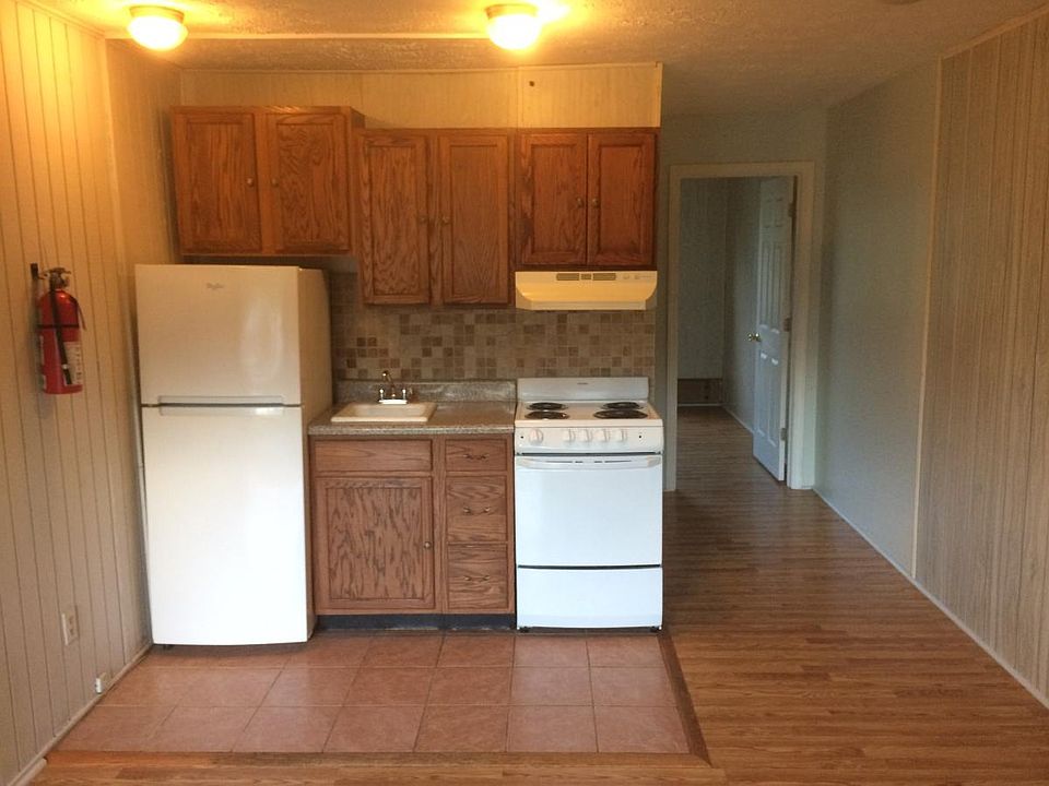 Kitchen/living area with new tile backsplash. Appliances upgraded in 2018.