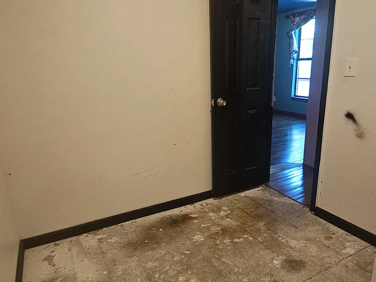 An unfinished in_suite closet, offering potential for a walk_in or custom storage build_out