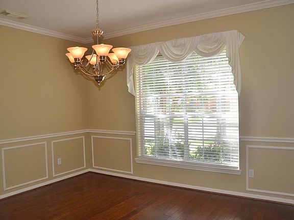 Formal dining room with  wood floors, pretty light fixtures, etc..