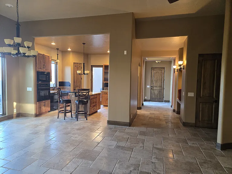 view from dining and living room to kitchen and entry hall way