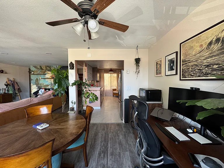Dining area facing toward kitchen. Living room area visible on left-side of picture.