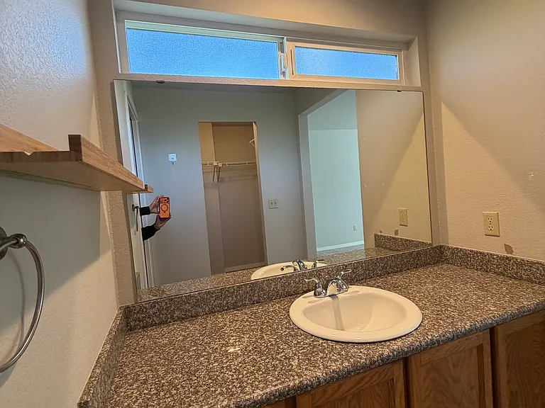 primary vanity with opening transom window above to listen to the sounds of nature