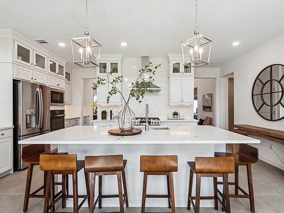 Kitchen with stacked glass-front upper cabinets over solid lowers