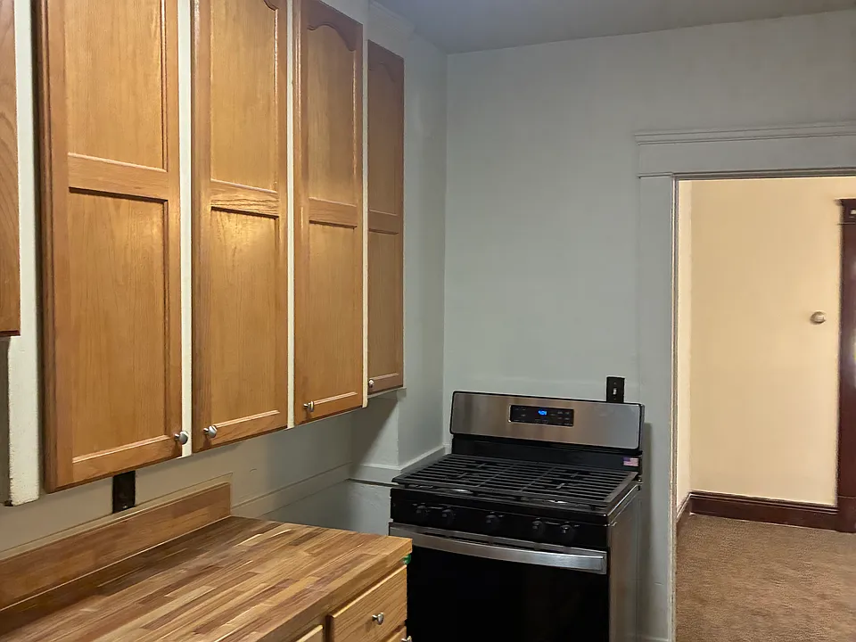 Complete kitchen renovation with new appliances, new stove and refrigerator, new countertop, sink, and built in cabinets, and new flooring.