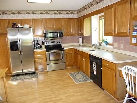 kitchen has brand new stove and refrigerator