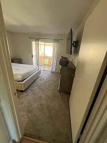 Bedroom #1, brand new carpet, with sliding doors to back balcony