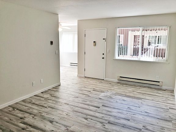 Unit 4 living room and dining room: Brand new elegant flooring resembling hardwood! Double pane windows.