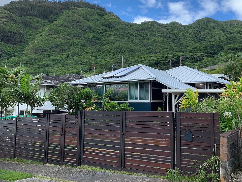 Enjoy a fully, gated, fenced yard. Six-foot, custom wood fence offers plenty of privacy and security. 2 cars can park in driveway. 1 space is covered. 400sqft carport/workshop with additional fridge and freezer.