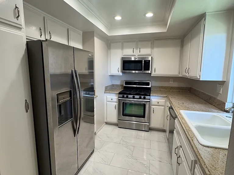 Recessed lighting, plenty of cabinet space, stainless steel refrigerator
