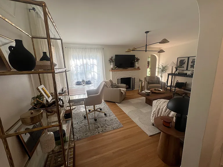 Living room with desk and glass bookcase