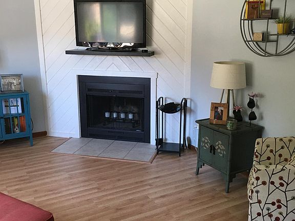 Living room 1. New flooring, working wood burning fireplace, new overhead ceiling fan.