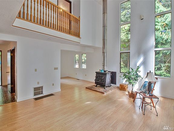 Living area with vaulted ceilings and wood stove.
