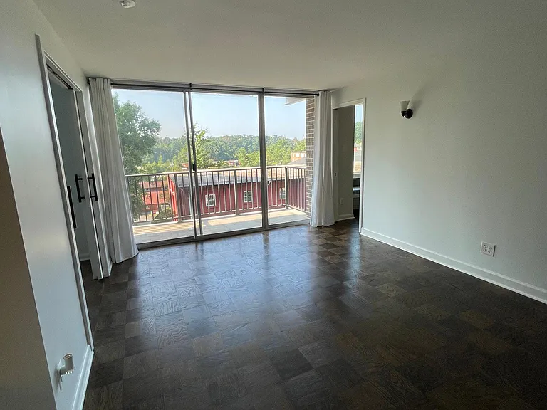 View from the front door to the balcony doors, which were updated in 2025. See pictures with black doors now.
