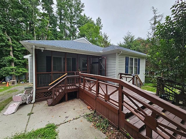 Front of home showing Screened Porch & walkway