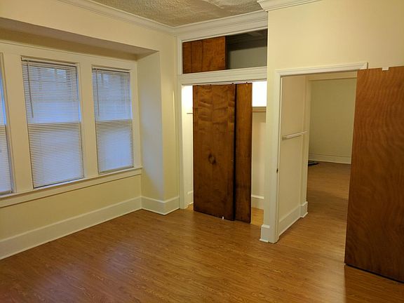 bedroom with closet (living room is seen through doorway)