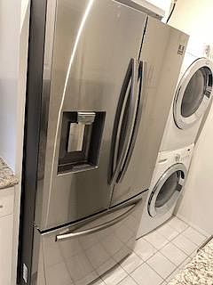 Wonderful stainless steel French style door refrigerator with pouring station for water and ice. Bottom tour freezer with two separate shelves.