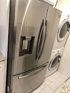 Wonderful stainless steel French style door refrigerator with pouring station for water and ice. Bottom tour freezer with two separate shelves.