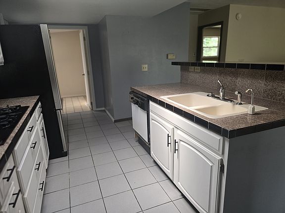 KITCHEN LOOKING AT LAUNDRY ROOM