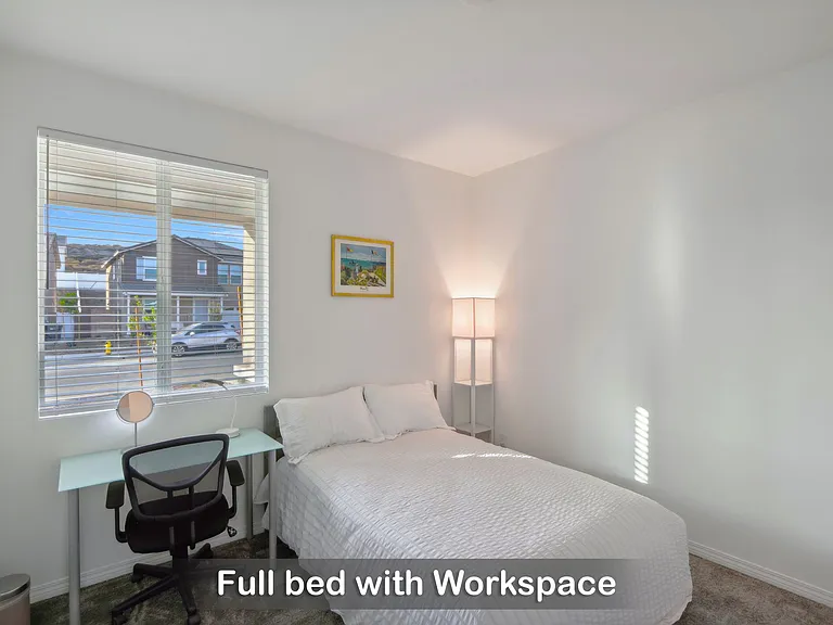 Full bed with a workspace, perfect for a comfortable stay and getting things done.
