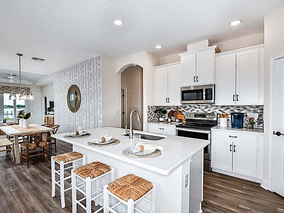 Cypress model home plan kitchen dining area new construction home at BridgeWater by William Ryan Hom