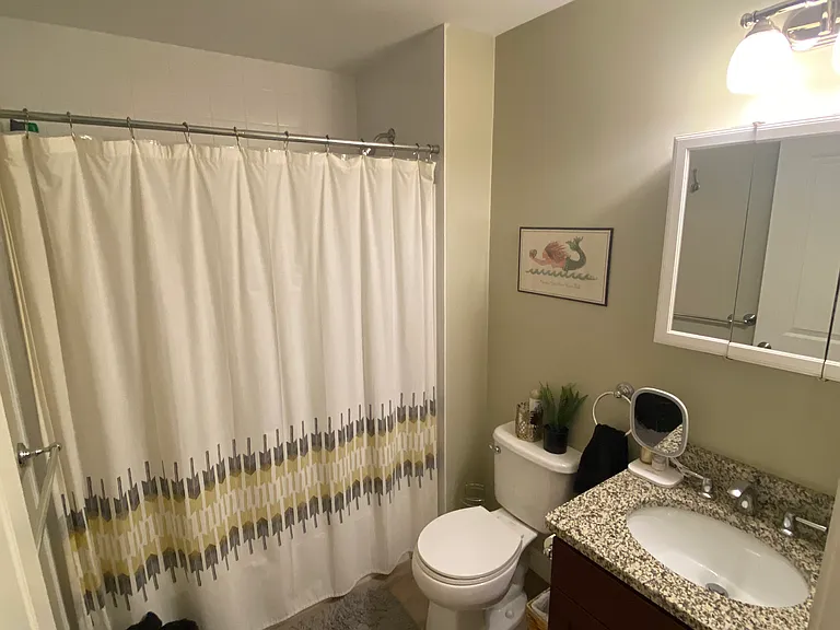 Main floor full bathroom. Ceramic tile on floor. Granite countertop.
