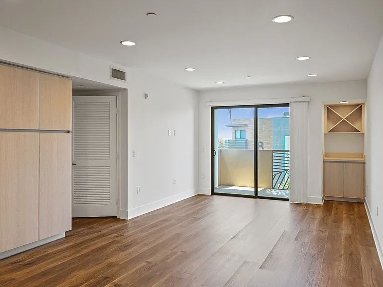 Living Room Area with Cabinet Storage , Bar, and Patio