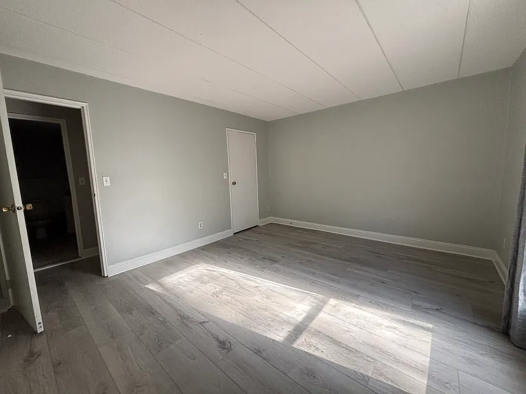 This is the bedroom without furniture. The closed door is to the walk-in closet.