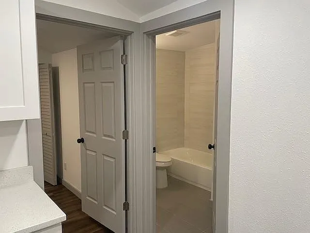 bedroom entrance to the left, bathroom to the right