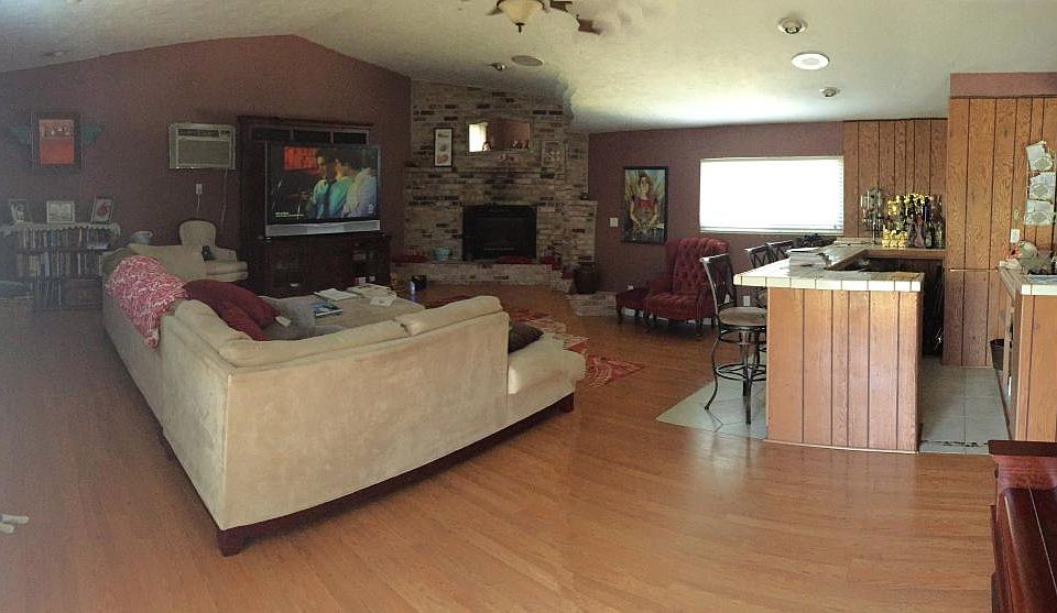 Living room with built in bar and fire place