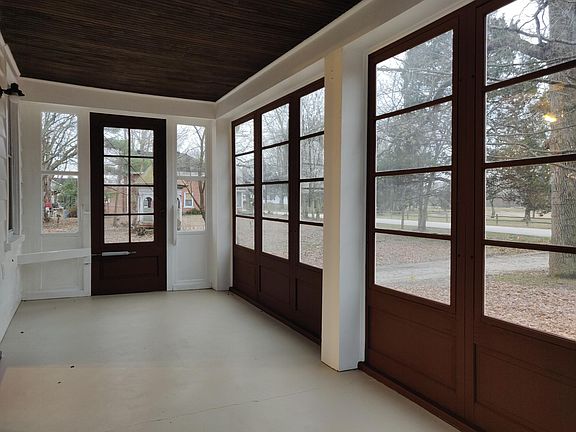 Glassed or screened front porch. Plenty of space for Amazon parcels, porch swing, or glider.