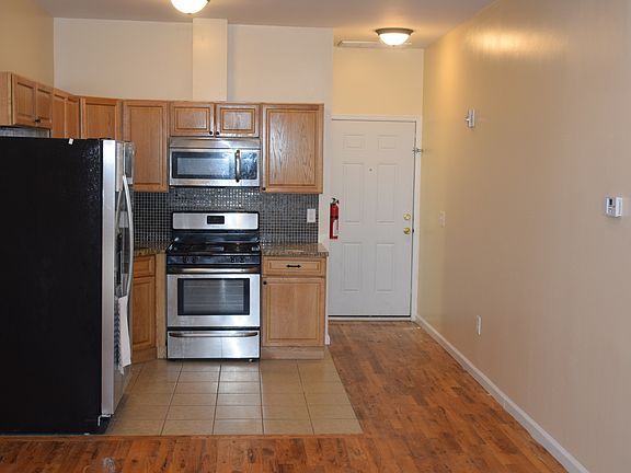 Living area facing kitchen and entrance