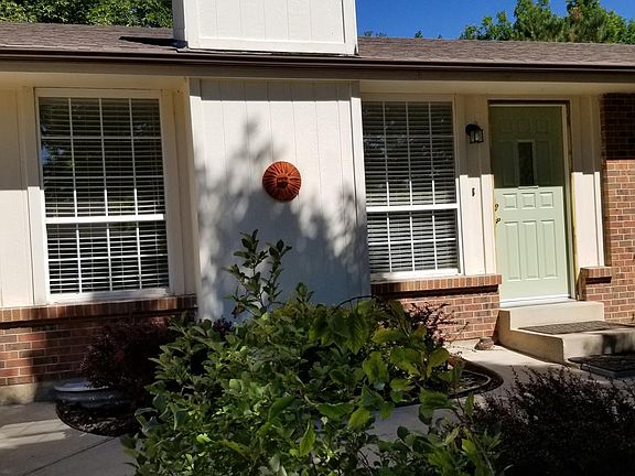 Front door of home, living room windows