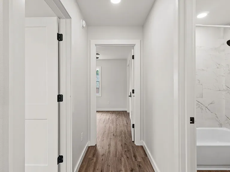 hallway (to the left of the house if you are standing facing the front door) to the 1st bedroom and master bedroom