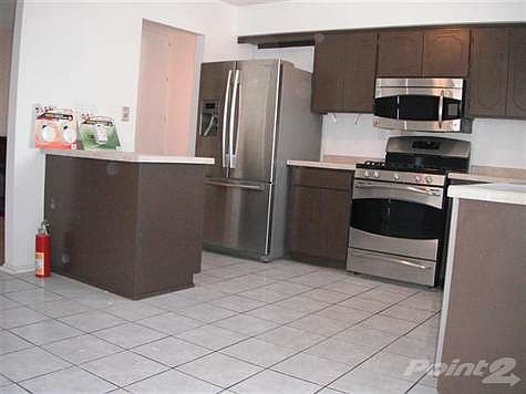 nice kitchen counter tops and lots of storage cabinets. Tile floor at kitchen and dining area. Refrigerator does not stay.