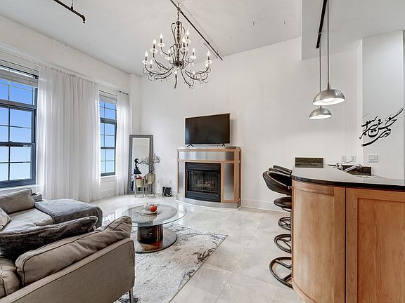 Living room with floor-to-ceiling windows & gas fireplace!