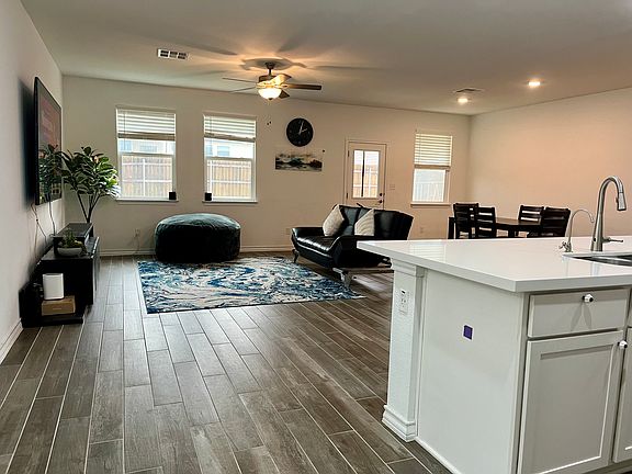 4. Living Room: Spacious open floor plan lit up using 6 large windows and a few LEDs