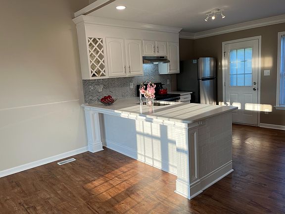Kitchen, with breakfast bar and wine rack.