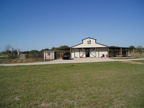 View of 4 stall horse barn with hay loft and living qtrs