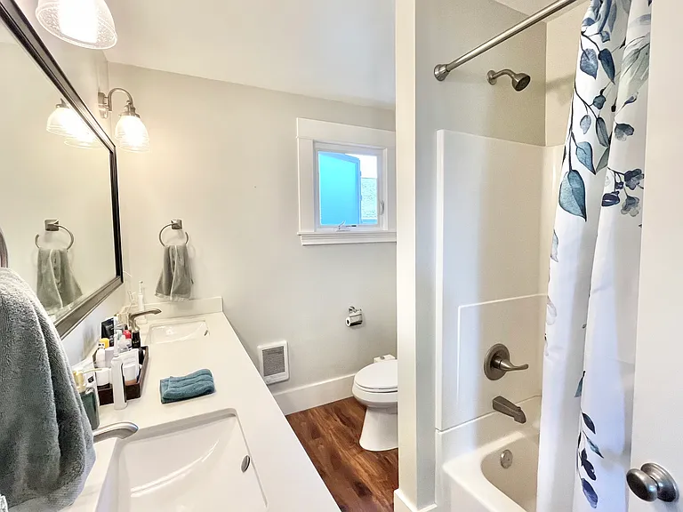 Ensuite bathroom off the primary, complete with double vanity and tub