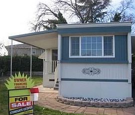 Nice stone walkway & grassy side yard with outside storage shed.