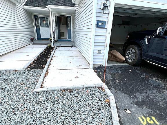 Newly poured concrete entry walkway, with pavers edging