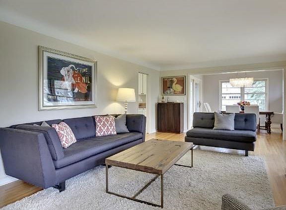 Spacious and lovely living room with coved ceilings, refinished HW floors, tons of (new Marvin) windows add to light and airy feel.