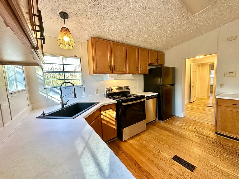 All new appliances in the kitchen. Electric range and stove, dishwasher and refrigerator. Redone countertops throughout. New sink and faucet.