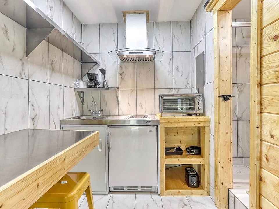 Kitchenette with refrigerator, stove and oven.