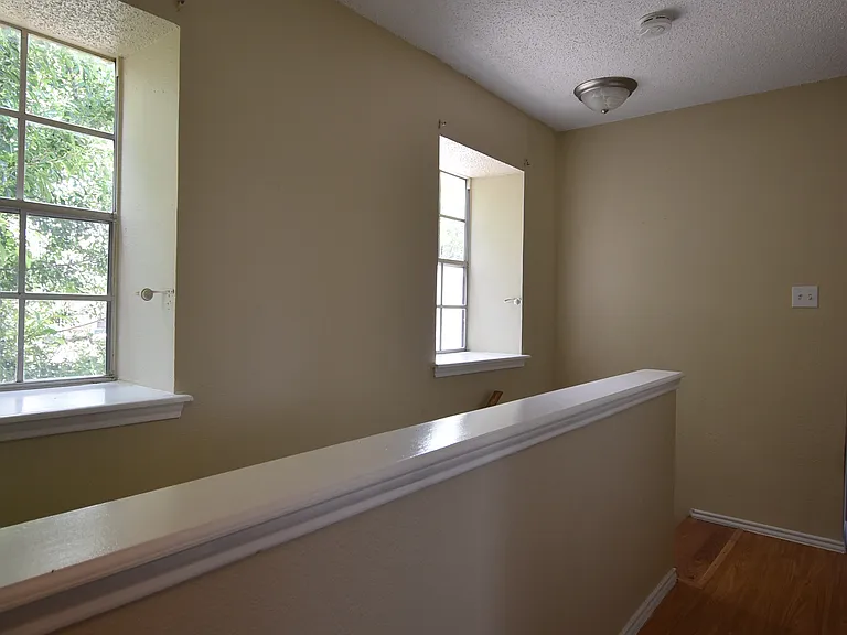 Upstairs hall connecting all three bedrooms and a common bath