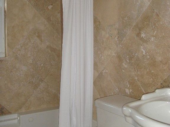 Bathroom w/ Jaccuzi tub and marble throughout