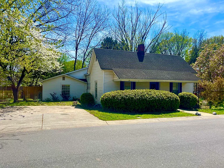 Two car parking deck to the left and entrance gate to backyard. RV outlets on side of house.