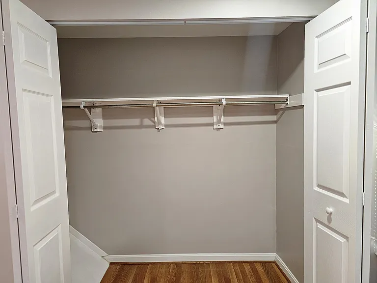 Master closet with overhead storage and large rack