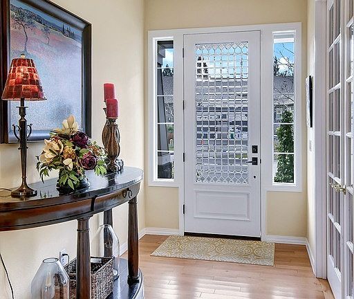 A covered front porch with a new leaded glass front door welcomes guests inside.